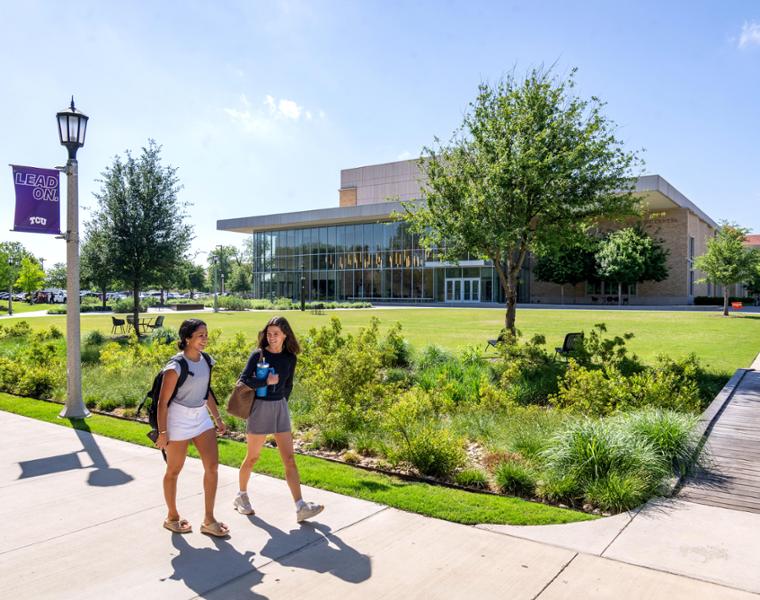 Students walk across the Creative Commons near the TCU Music Center, April 22, 2025. Photo by Jeffrey McWhorter.