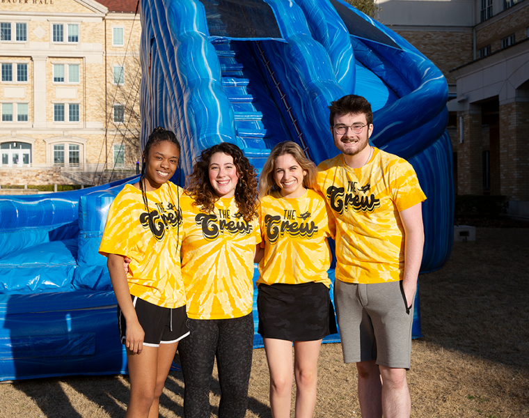 Four TCU Students in yellow The Crew Shirts