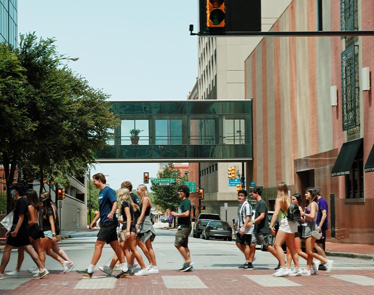 frog camp group walking in a crosswalk downtown