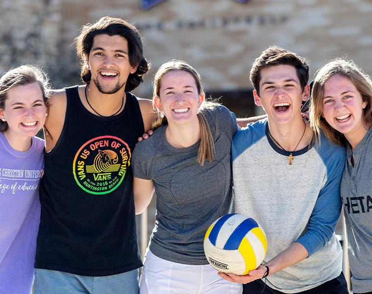students playing sand volleyball