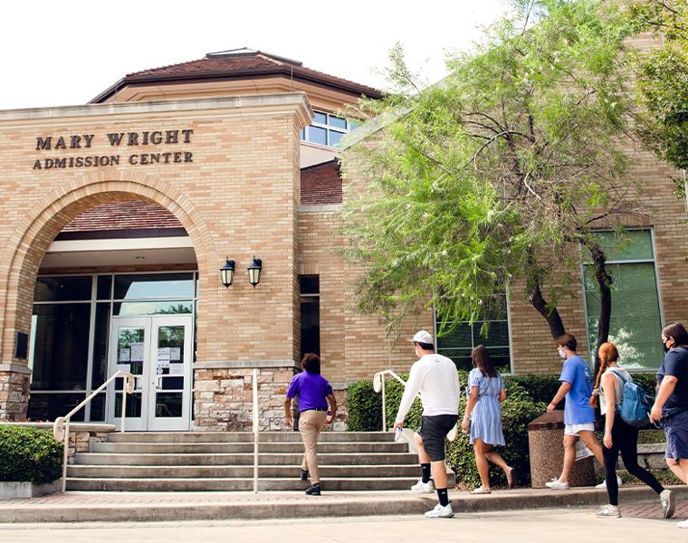 students from a tour entering the admission center