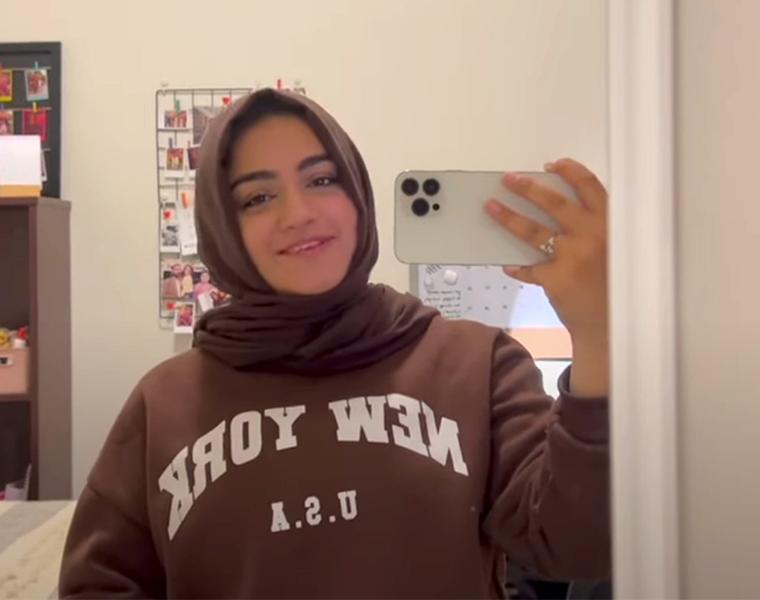 female student taking a selfie in her dorm 